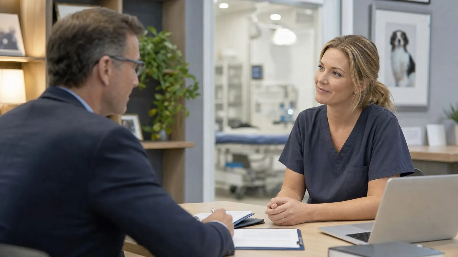 Veterinary practice owner discussing a confidential practice sale in a private animal hospital office