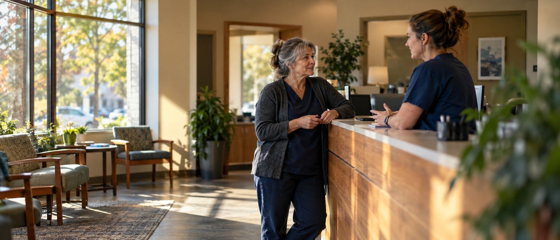 A practice owner talking with a colleague in the reception area of an independent practice